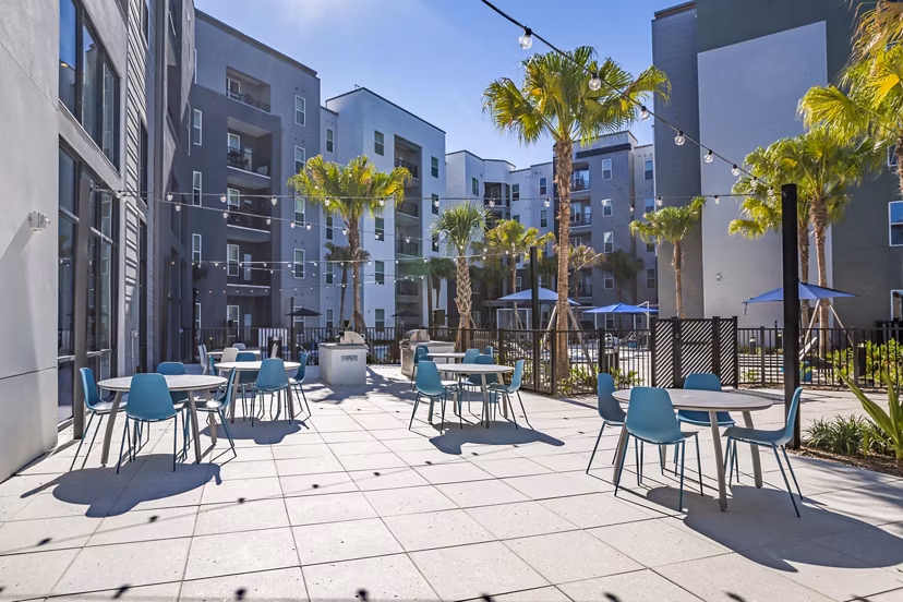Outdoor grill area on patio at The Accolade Collegiate Village West Apartments