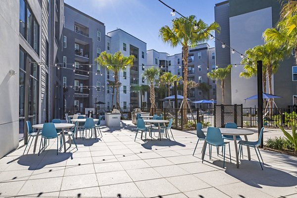 Outdoor grill area on patio at The Accolade Collegiate Village West Apartments