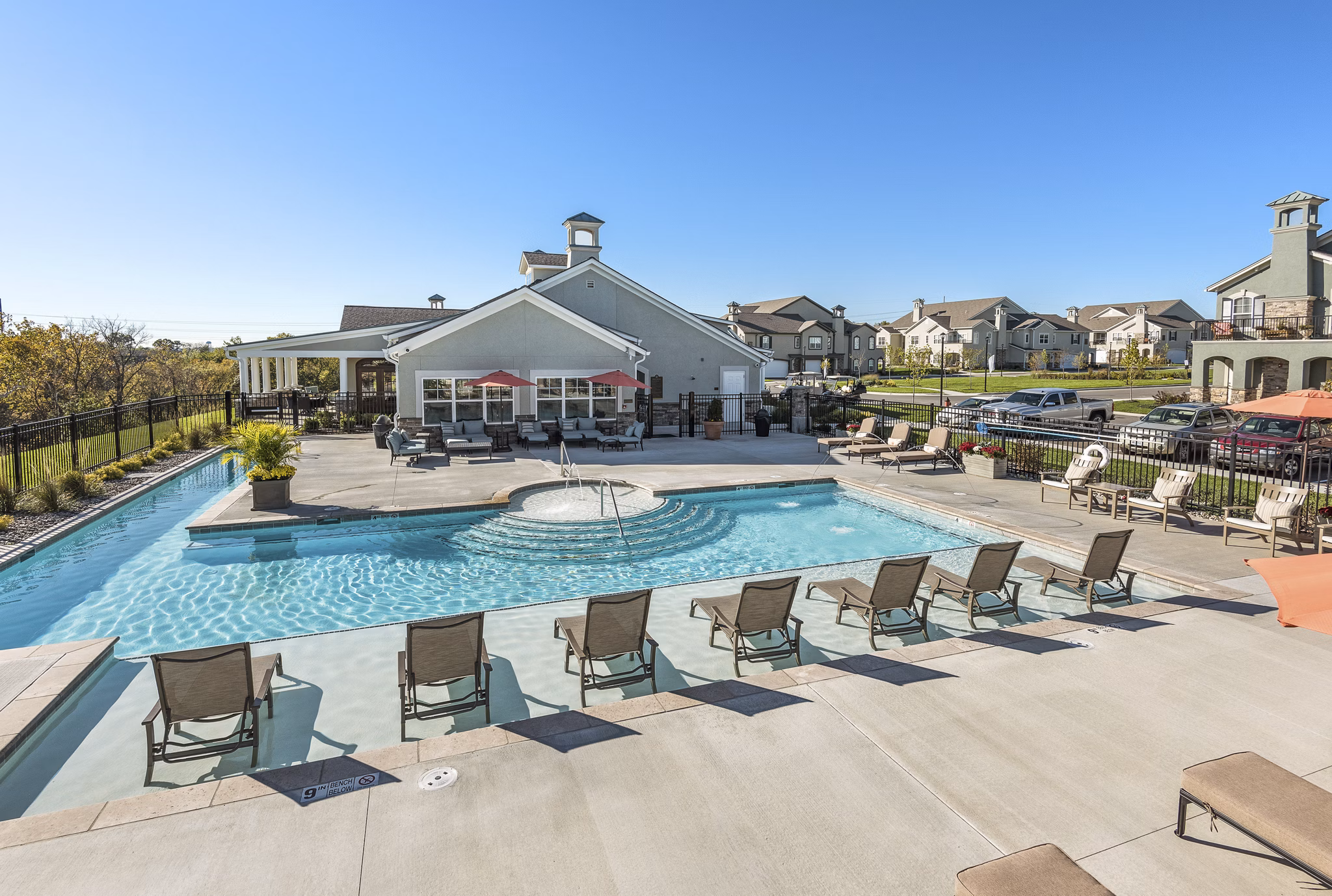 Relaxing poolside retreat at Savannah West Apartments, featuring sun loungers and lush landscaping