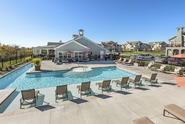 Relaxing poolside retreat at Savannah West Apartments, featuring sun loungers and lush landscaping