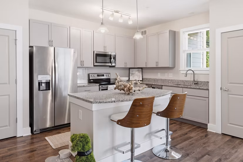 Modern kitchen with stainless steel appliances at The Arden Apartments, featuring sleek cabinetry and contemporary design elements