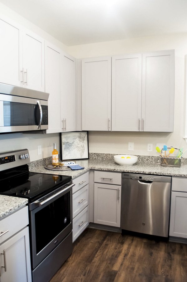 Modern kitchen with stainless steel appliances at The Arden Apartments, featuring sleek cabinetry and contemporary design elements
