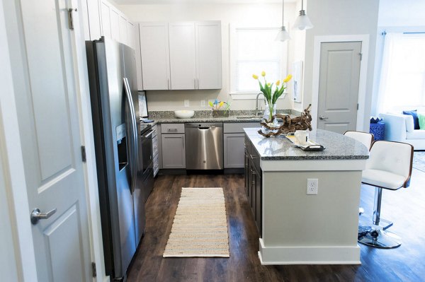 Modern kitchen with stainless steel appliances at The Arden Apartments, luxury living at its finest
