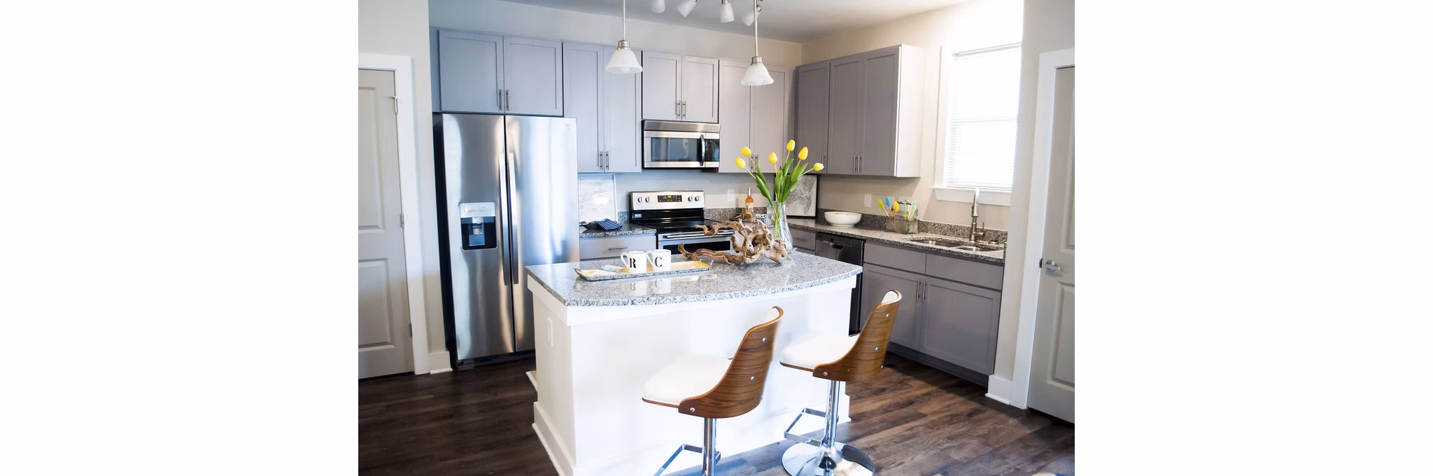 Modern kitchen with stainless steel appliances and quartz countertops at The Arden Apartments in luxury community