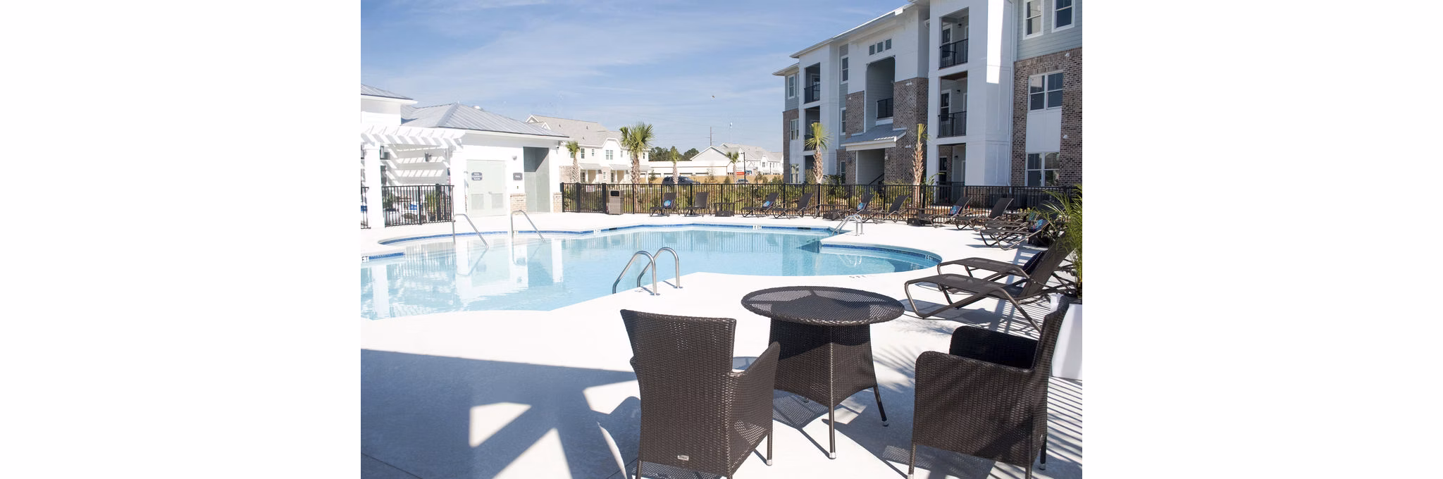 Resort-style pool at The Arden Apartments with lush landscaping and ample lounging areas