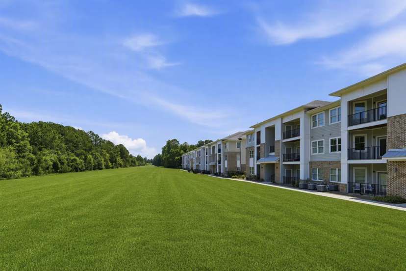 Community pool surrounded by luxury loungers at The Arden Apartments
