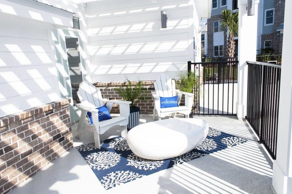 Community pool surrounded by luxury loungers at The Arden Apartments