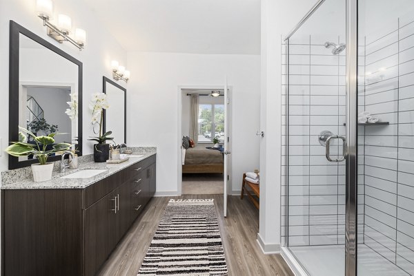 Modern bathroom with sleek fixtures at Album Huntersville Apartments, offering luxury living in a serene community