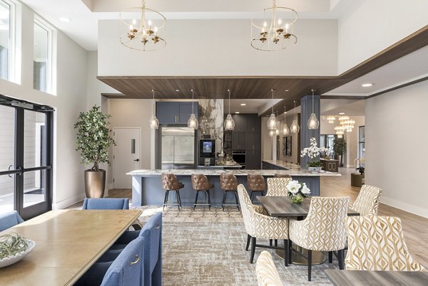 Modern clubhouse with comfortable seating and game tables at Album Huntersville Apartments for social gatherings and events