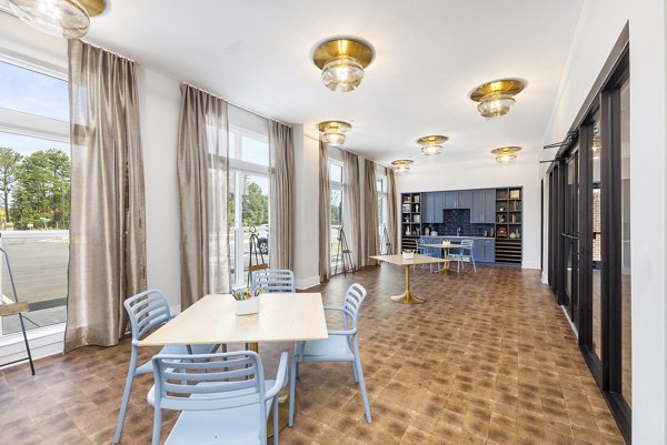 Clubhouse featuring stylish seating and community space at Album Huntersville Apartments