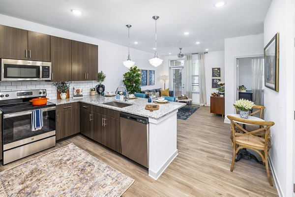 Modern kitchen with stainless steel appliances at Album Huntersville Apartments