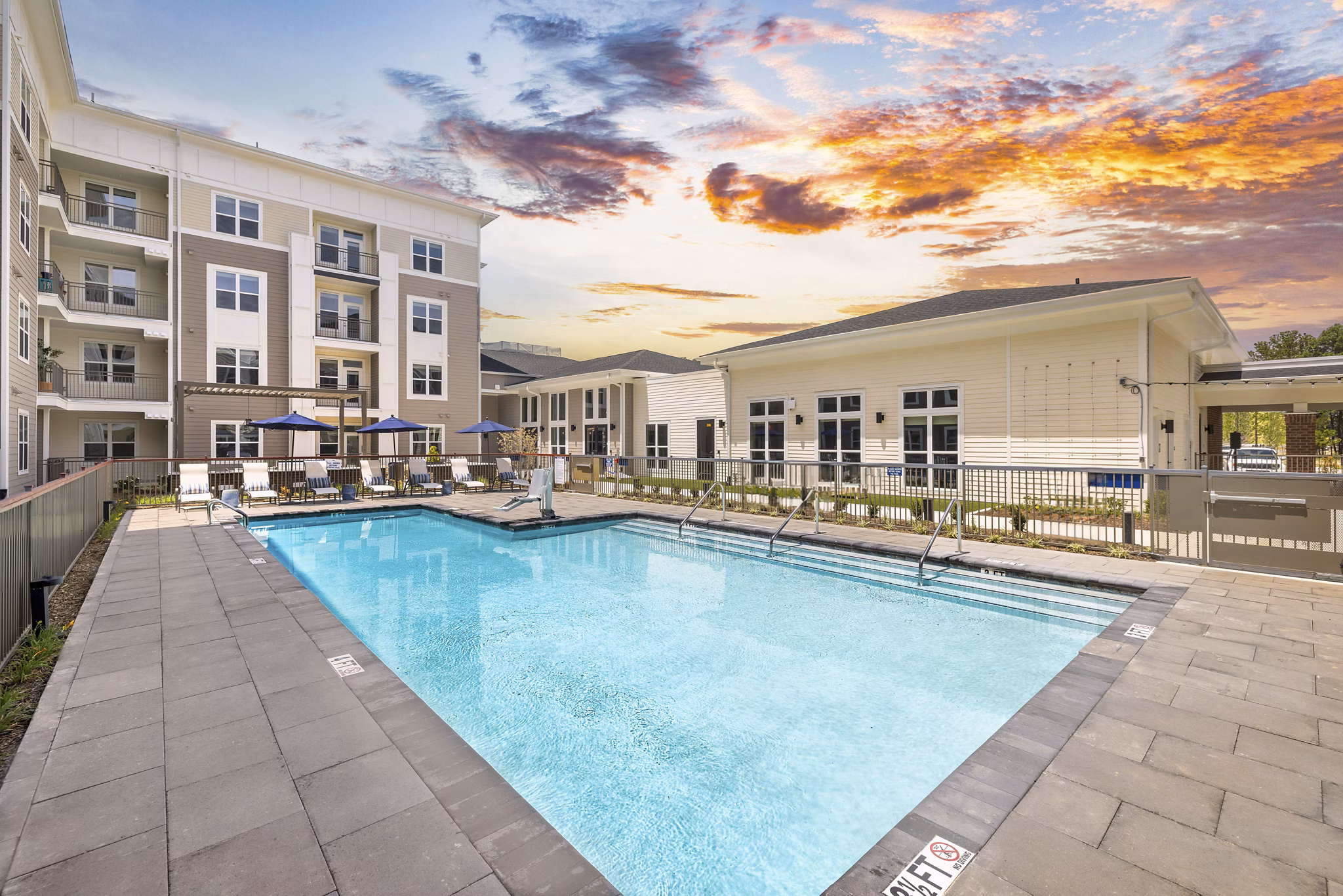 Luxury outdoor pool with lounging areas at Album Huntersville Apartments