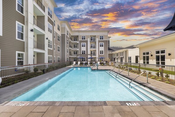 Resort-style pool area at Album Huntersville Apartments offering luxury leisure amenities