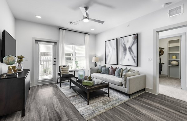 The Vaughan Apartments: Contemporary living room with modern dÃ©cor and natural lighting