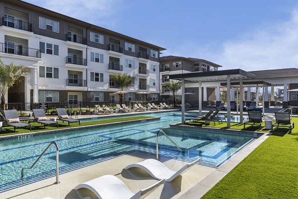 Refreshing pool with sundeck at The Vaughan Apartments, perfect for relaxing luxury living
