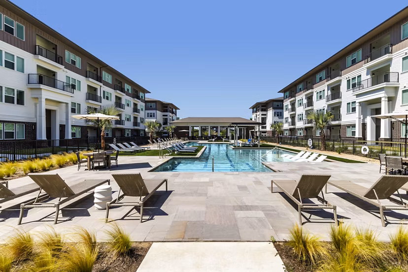 Spacious pool with lounge chairs at The Vaughan Apartments
