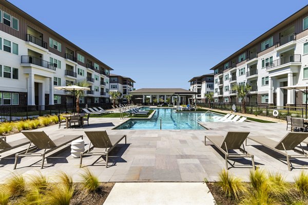 Spacious pool with lounge chairs at The Vaughan Apartments