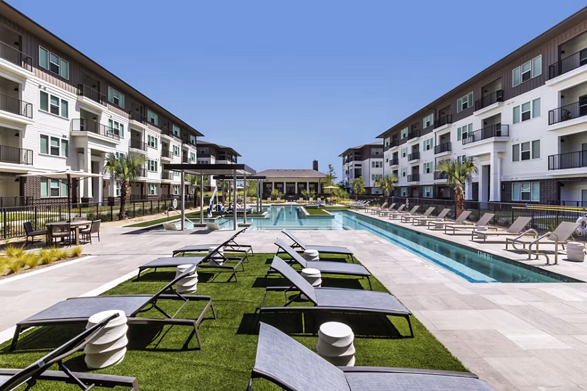 Resort-style rooftop pool with sun loungers at The Vaughan Apartments