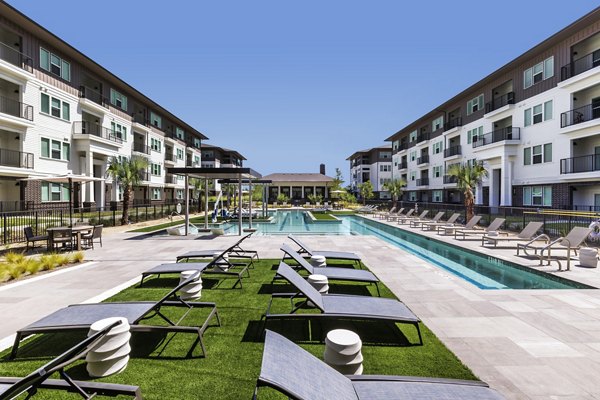 Resort-style rooftop pool with sun loungers at The Vaughan Apartments