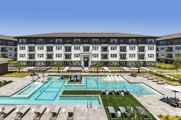 Outdoor pool with sun loungers at The Vaughan Apartments offering luxury living experiences