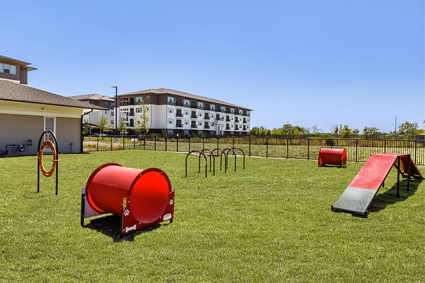 Spacious dog park with agility equipment at The Vaughan Apartments