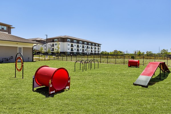 Spacious dog park with agility equipment at The Vaughan Apartments