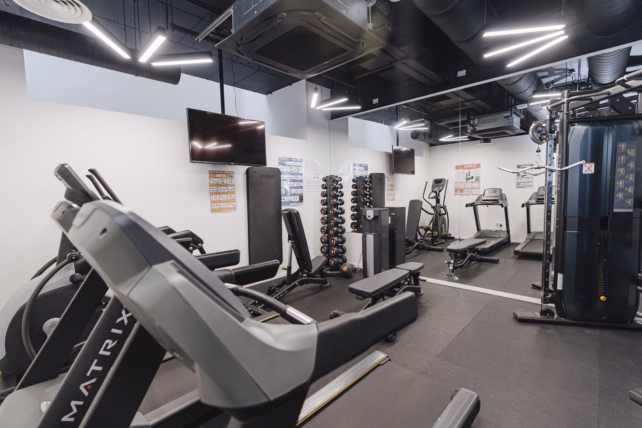 Well-equipped fitness room at Chapter Westminster with treadmills, weight machines, and modern gym amenities.