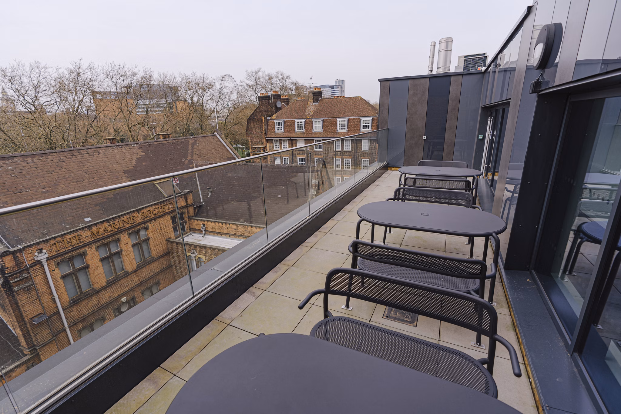 Private patio area at Chapter Westminster with outdoor seating and views of the surrounding cityscape.