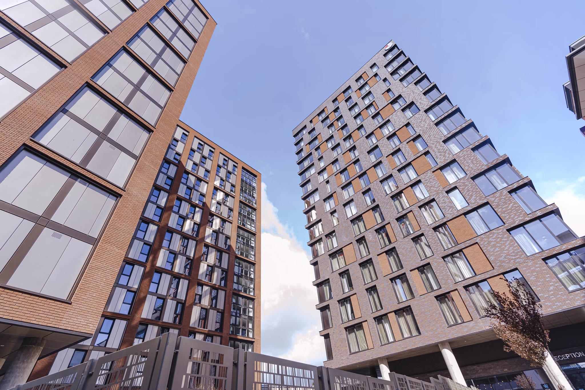 Exterior view of Canvas Coventry City Club in Coventry, showcasing its modern multi-story architectural design against a bright sky.