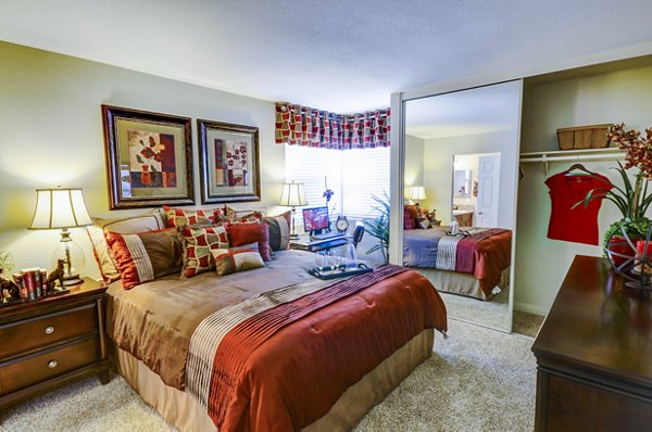 Bedroom with modern decor and large window in Adagio Apartments: luxury living at Greystar's premier property