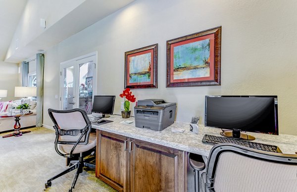 Contemporary business center featuring modern workstations at Adagio Apartments