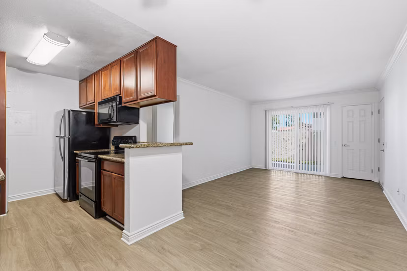 Modern kitchen featuring stainless steel appliances and granite countertops in Adagio Apartments luxury community