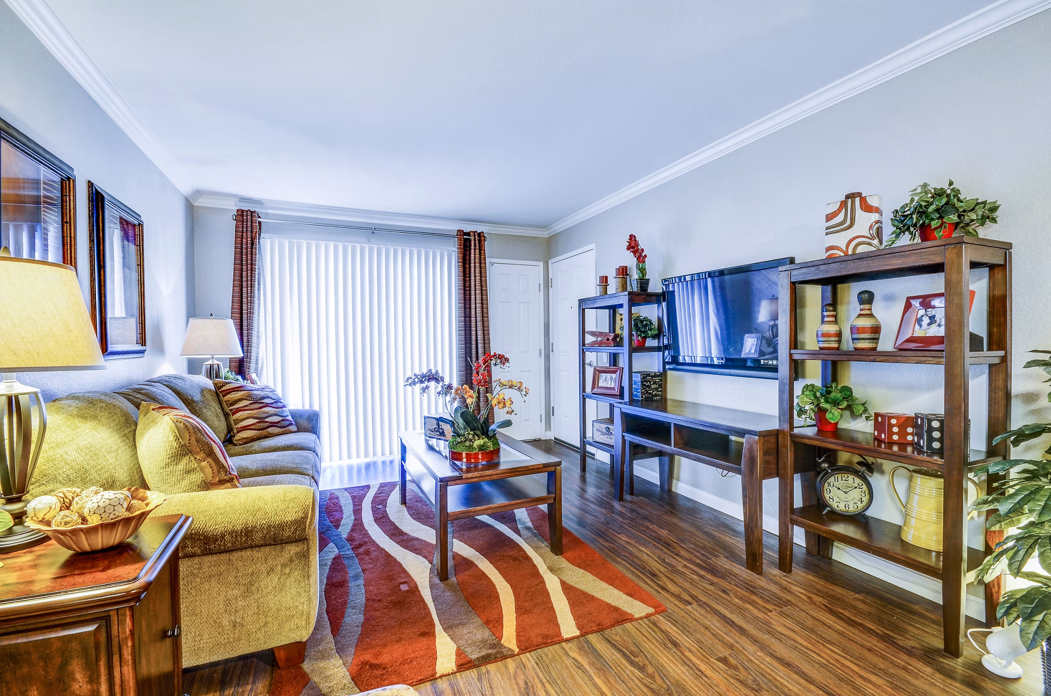 Living room with modern furnishings and large windows at Adagio Apartments