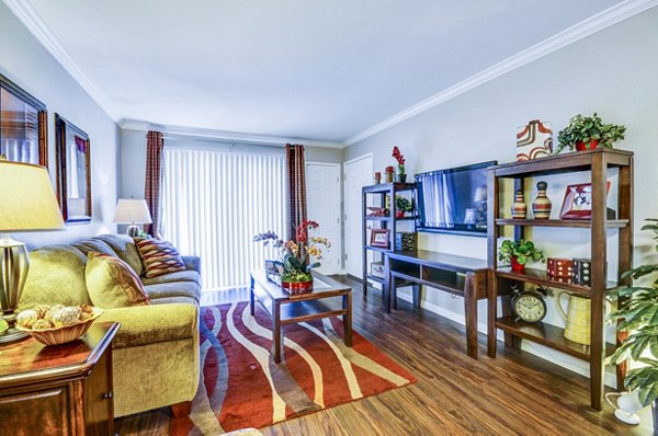 Living room with modern furnishings and large windows at Adagio Apartments