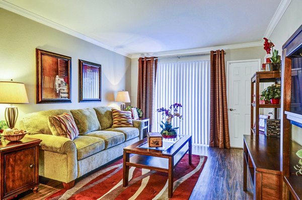 Spacious living room with modern furnishings and natural light in Adagio Apartments