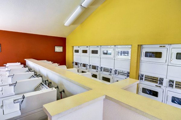 Modern laundry facility with energy-efficient machines at Adagio Apartments, featuring convenience and comfort for residents
