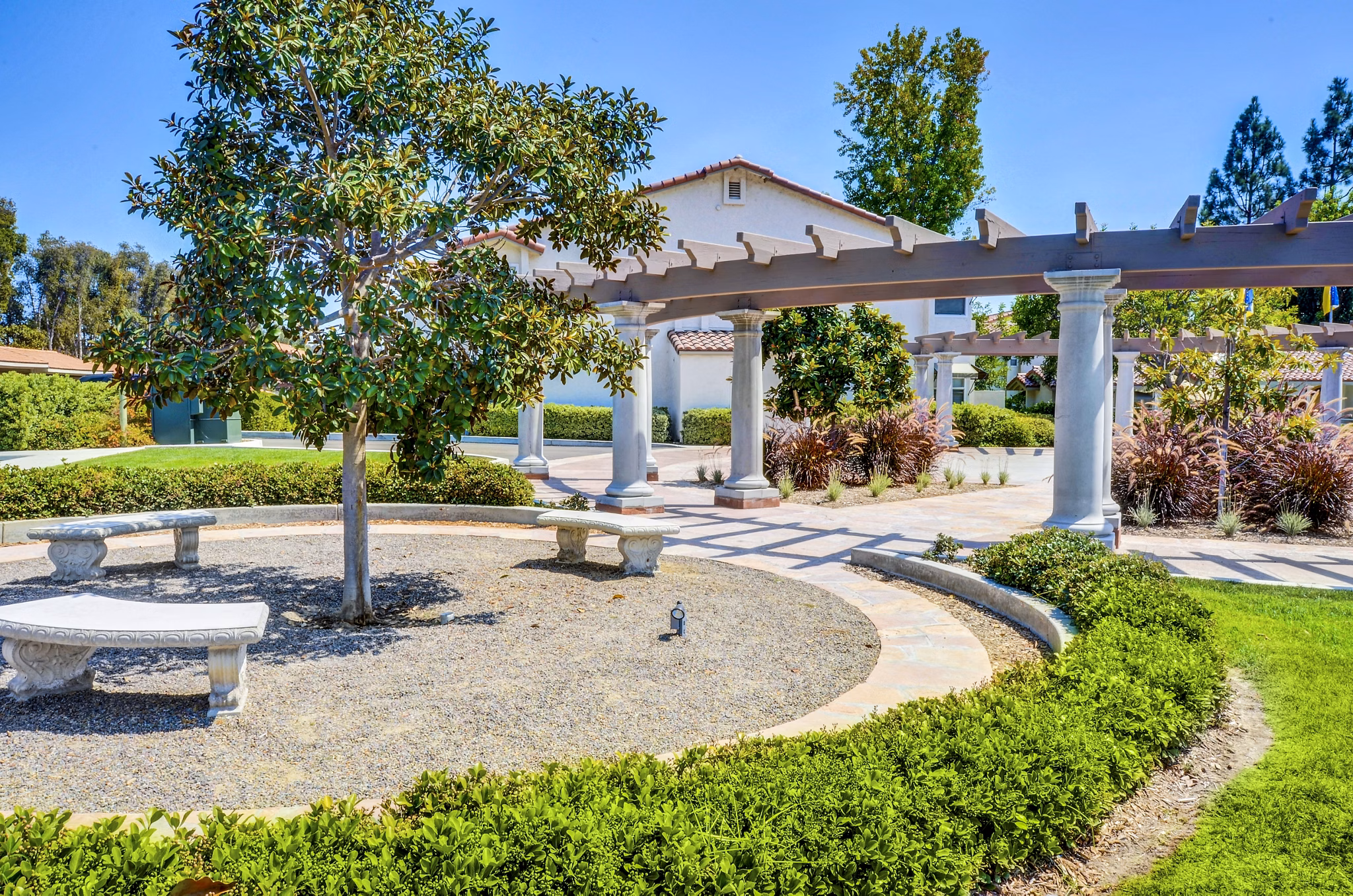 Adagio Apartments: Serene courtyard with lush greenery and seating areas