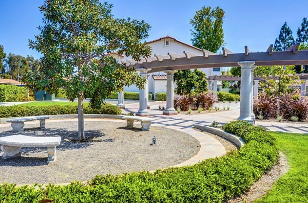 Adagio Apartments: Serene courtyard with lush greenery and seating areas