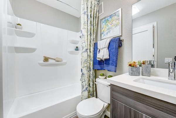 Altair Apartments: Modern bathroom with sleek fixtures and tile accents