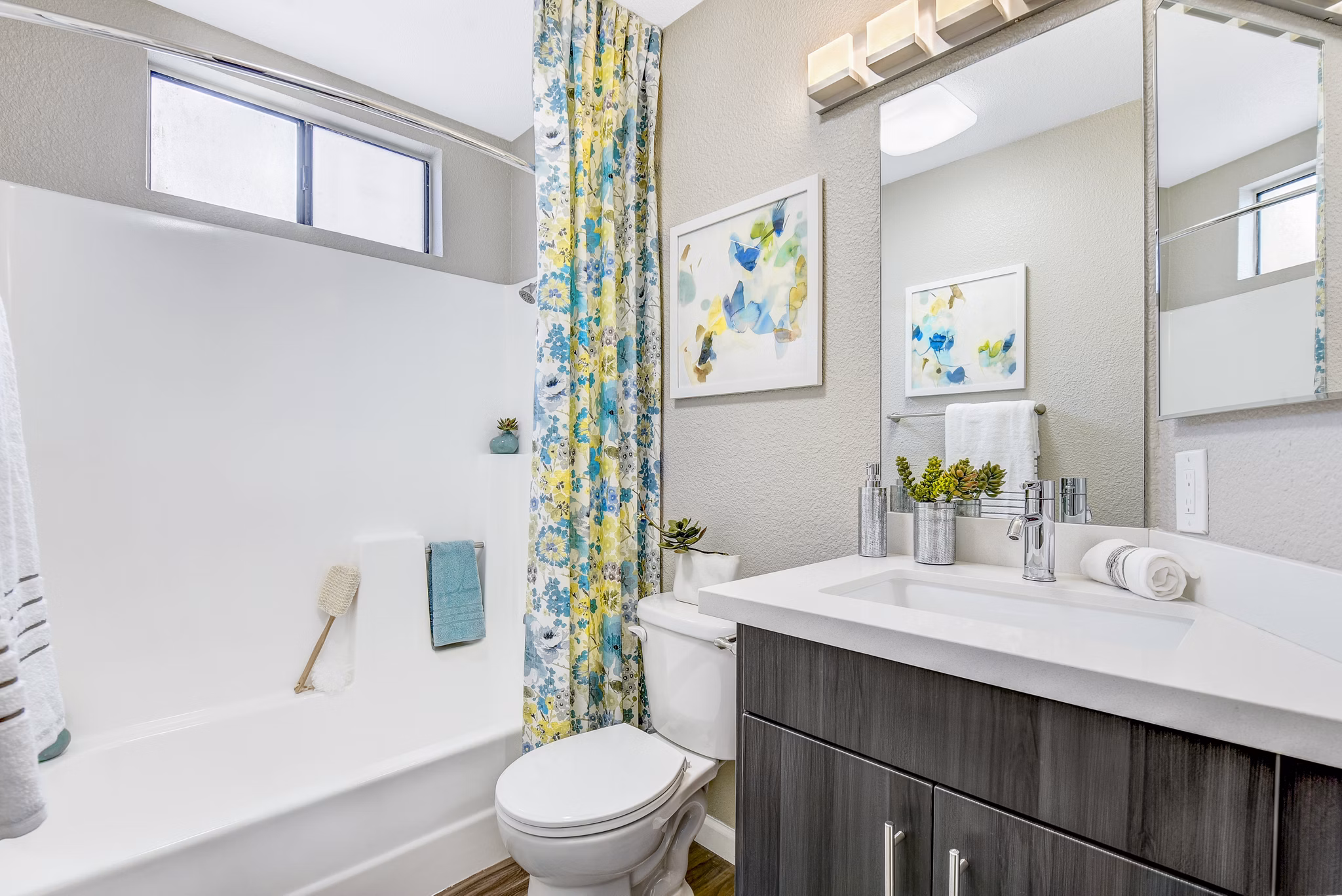 Modern bathroom with marble countertops and sleek fixtures at Altair Apartments