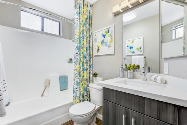 Modern bathroom with marble countertops and sleek fixtures at Altair Apartments