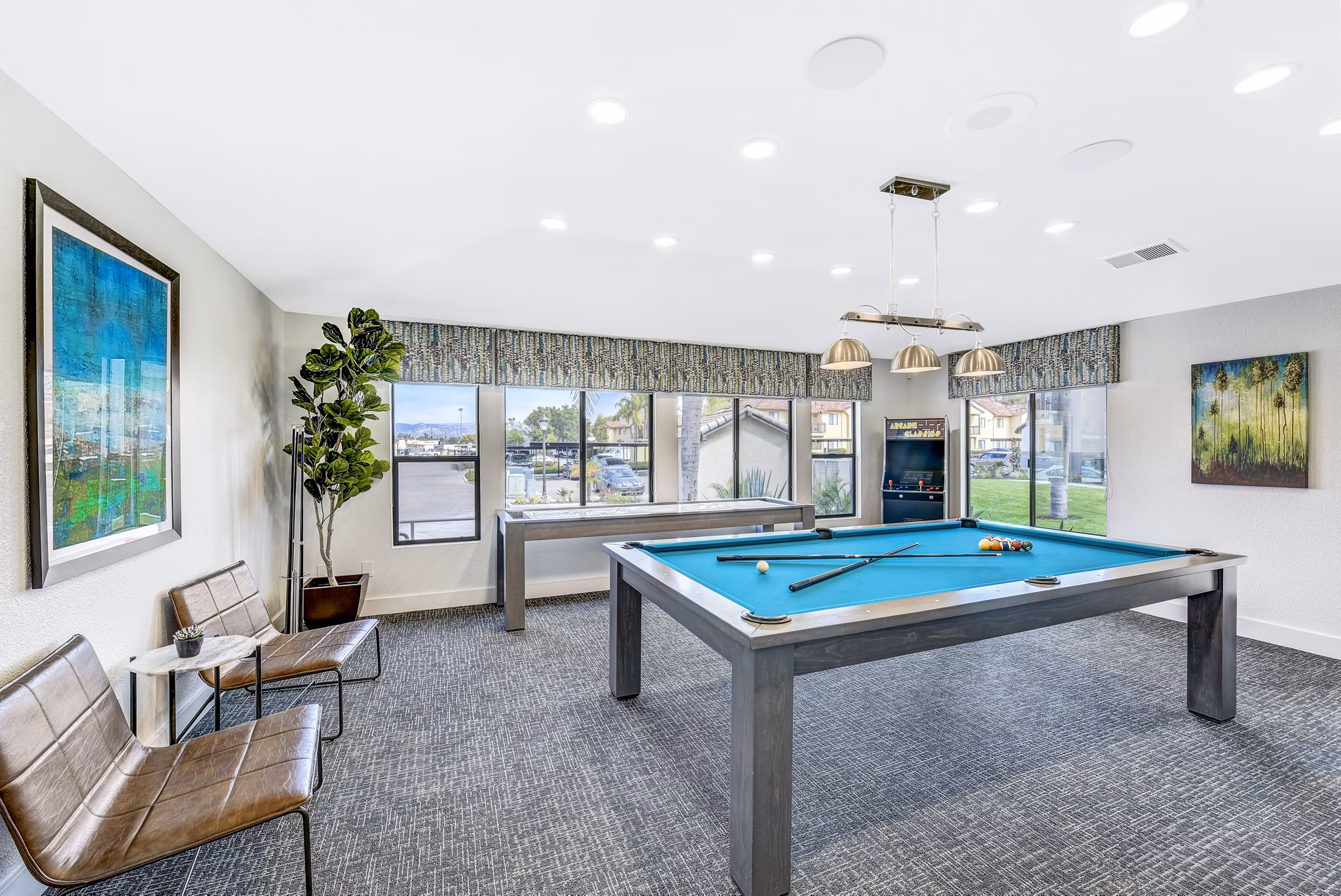 Altair Apartments: Stylish clubhouse game room with pool table and lounge seating