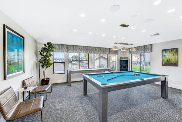 Altair Apartments: Stylish clubhouse game room with pool table and lounge seating