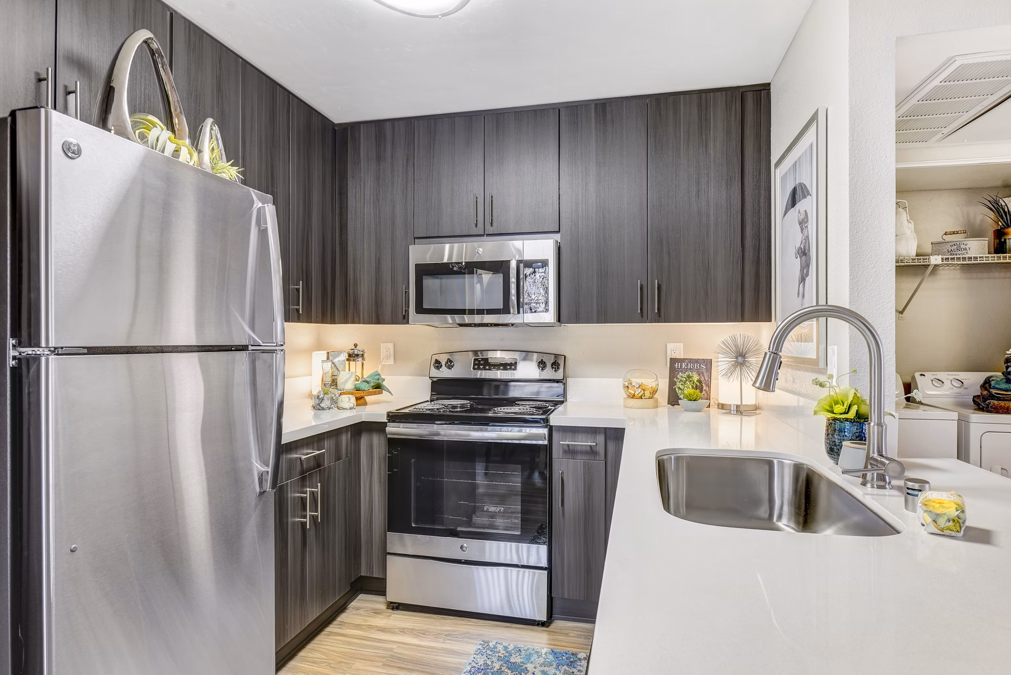 Modern kitchen featuring stainless steel appliances and granite countertops at Altair Apartments