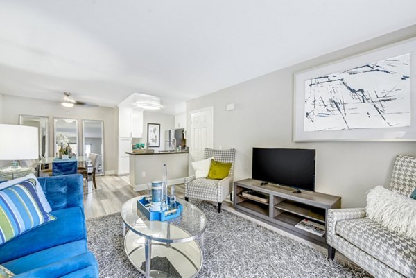 Living room with modern furnishings and natural light at Altair Apartments