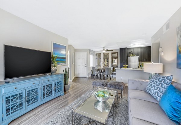 Elegant living room with sleek furnishings at Altair Apartments, featuring ample natural light and modern design elements