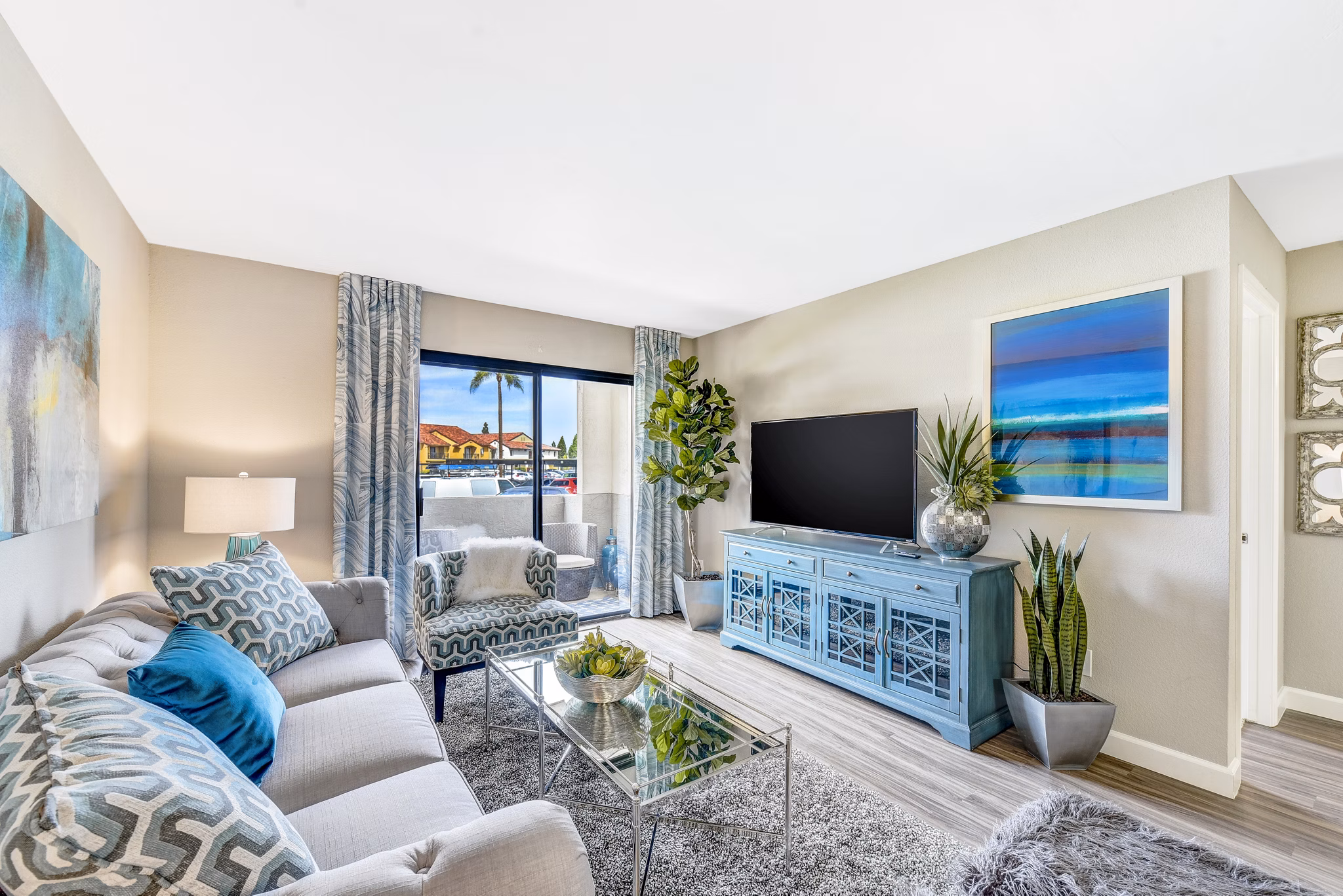 Altair Apartments: Cozy living room with modern decor and large windows, offering a luxurious atmosphere and natural light