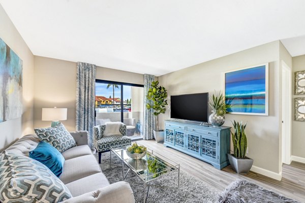 Altair Apartments: Cozy living room with modern decor and large windows, offering a luxurious atmosphere and natural light