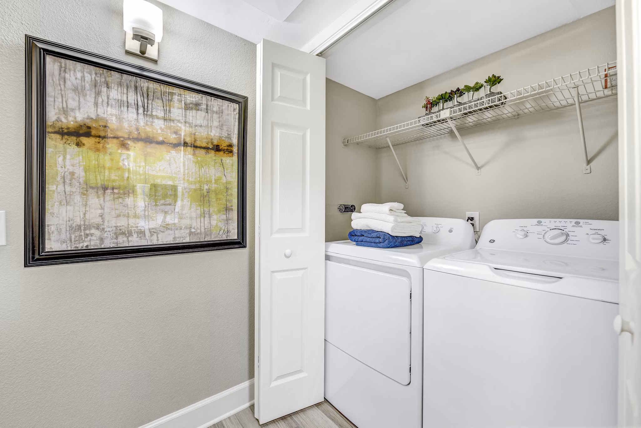 Laundry room featuring modern washers and dryers in Altair Apartments