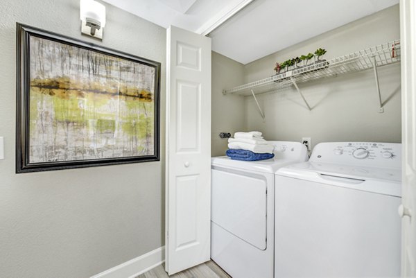 Laundry room featuring modern washers and dryers in Altair Apartments